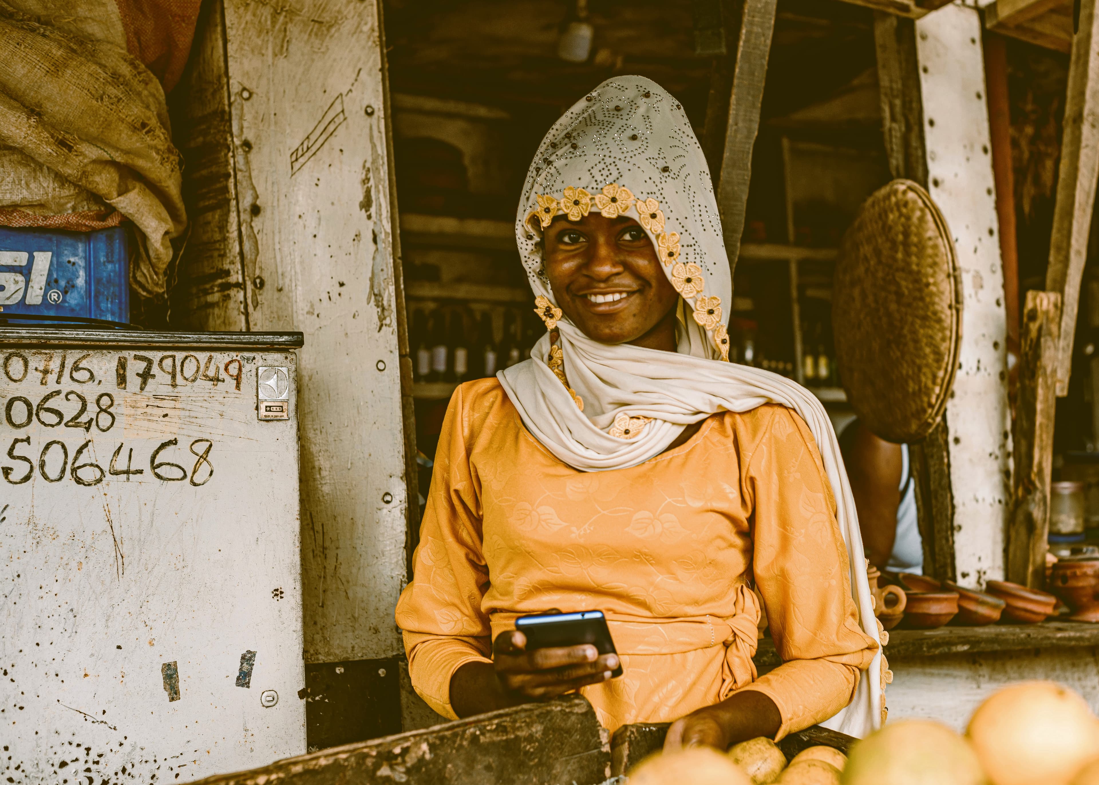 A market seller taking an order on her phone